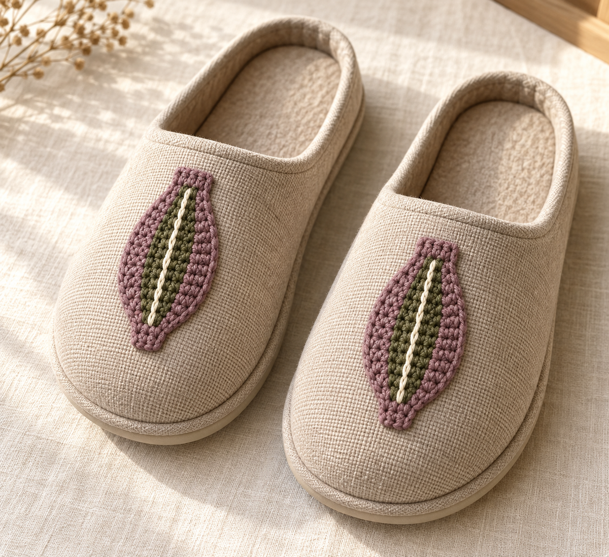 Generated design illustration: Two tapered single-crochet slipper tabs with olive centers and cream surface spines, shown on existing fabric slippers.